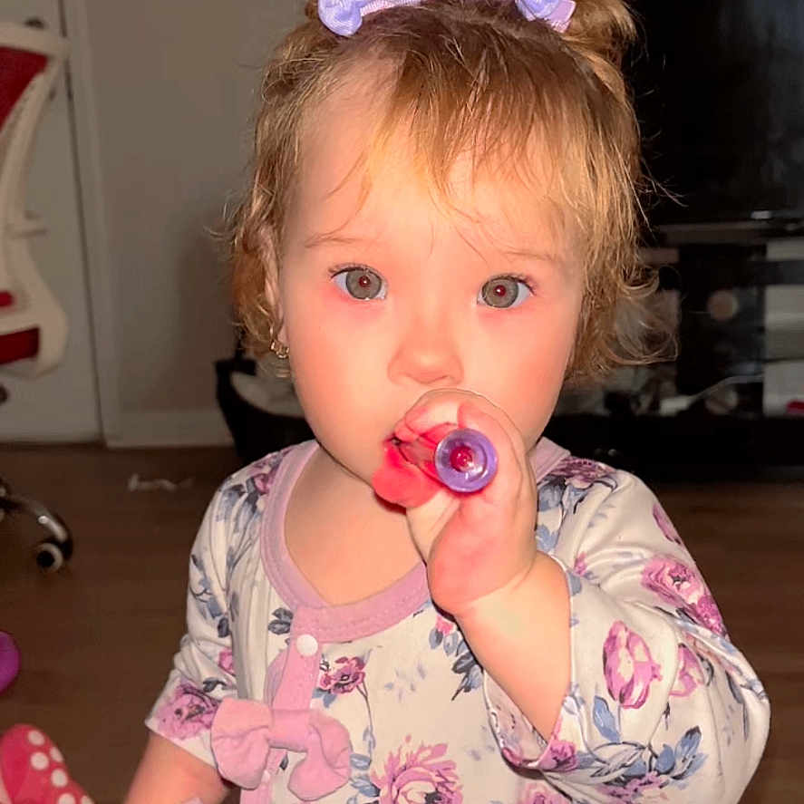 Victoria González joined the competition — help win amazing prizes! balloons, child, curious, cute, face, floor, floral_clothing, furniture, girl, hair_bow, home, indoor, person, pink, playing, portrait, purple, toddler, toy, young_child