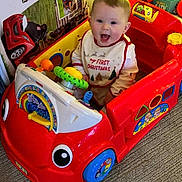 River joined the competition — help win amazing prizes! baby, bib, carpet, child, christmas, colorful, cute, decorations, festive, happy, holiday, indoor, infant, person, play, red, sitting, smiling, steering_wheel, toy_car