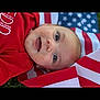 baby, infant, face, smile, red_clothing, american_flag, patriotic, outdoor, grass, happy, portrait, cute, child, young, lying_down, closeup, skin, eye, expression, celebration