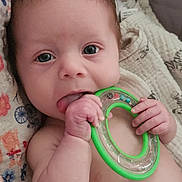 Shaderia is registered to the contest to win money with this photo: baby, infant, teething_toy, blanket, diaper, hand, face, blue_eyes, soft_hair, colorful, markers, patterned_fabric, cute, lying_down, skin, expression, indoors, child, young, playful