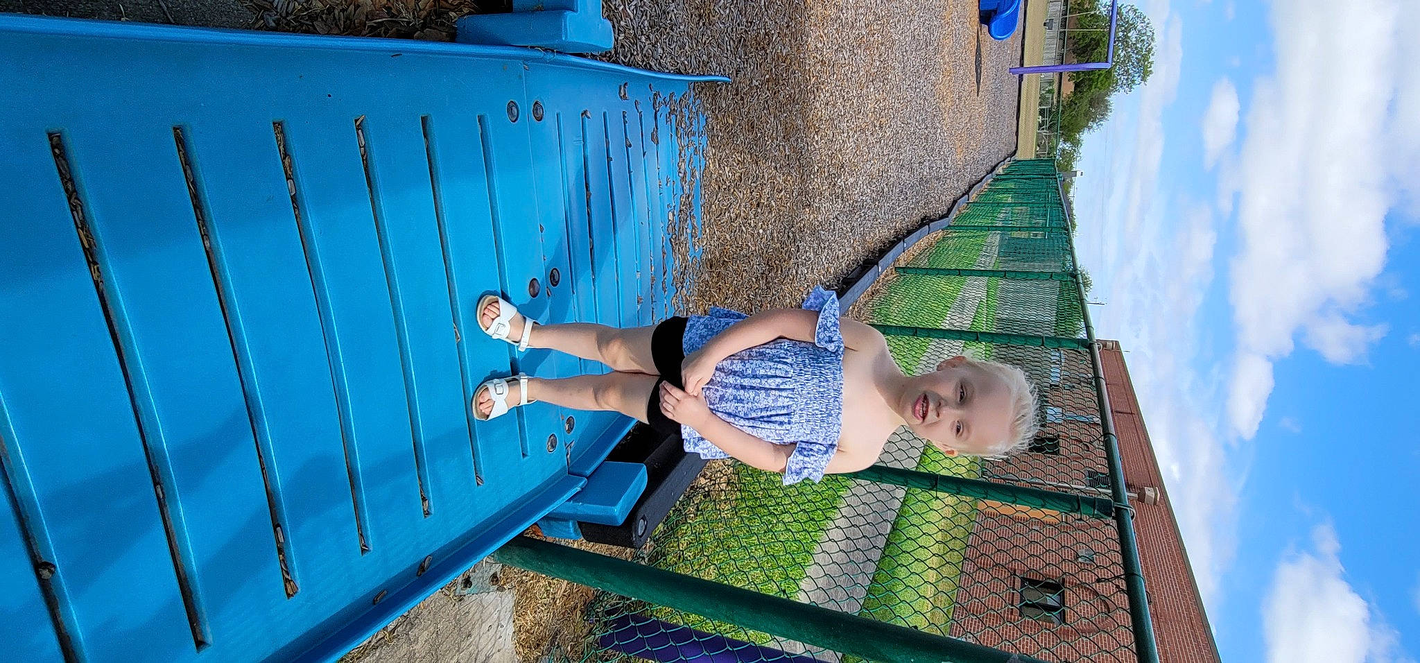 Korryn is registered to the contest to win money with this photo: blue, electric_blue, fun, grass, human_body, human_leg, leg, leisure, line, outdoor_furniture, people_in_nature, person, recreation, shorts, sky, snapshot, summer, thigh, toddler, water