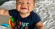 Kreedence is registered to the contest to win money with this photo: baby, bed, blanket, child, clothing, curly_hair, cute, furniture, happy, home, indoor, infant, joy, person, playful, reaching, shirt, smiling, toddler, toy