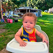Kreedence is registered to the contest to win money with this photo: baby, backyard, barcelona, child, curly_hair, cute, grass, greenery, happy, high_chair, nature, outdoor, person, portrait, seat, sports_jersey, summer, sunny, toddler, trees