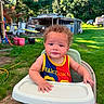 baby, backyard, barcelona, child, curly_hair, cute, grass, greenery, happy, high_chair, nature, outdoor, person, portrait, seat, sports_jersey, summer, sunny, toddler, trees