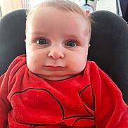 Charly a rejoint le concours — aidez-le/la à gagner de superbes lots ! baby, child, red_sweater, face, indoors, christmas_tree, holiday_decor, wide_eyes, cute, portrait, seated, furniture, soft_lighting, infant, expression, close_up, cozy, young_child, warm_colors, home