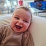 Charly a rejoint le concours — aidez-le/la à gagner de superbes lots ! baby, child, chubby_cheeks, closeup, couch, cute, eyes, face, hair, happy, human, indoor, infant, laughing, living_room, onesie, open_mouth, pillow, portrait, smiling