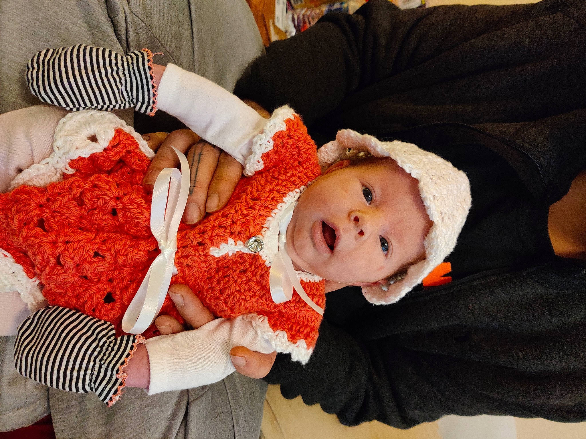 Astrid joined the competition — help win amazing prizes! arm, baby, baby_products, baby_sleeping, baby_toddler_clothing, cheek, child, comfort, hand, happy, headwear, lap, nail, pattern, person, sitting, skin, sleeve, smile, toddler