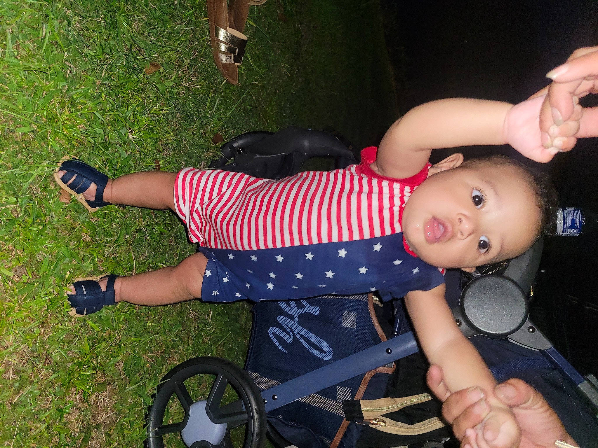 Ja'Carri is registered to the contest to win money with this photo: baby, baby_products, baby_toddler_clothing, black, finger, fun, grass, happy, human_leg, joint, knee, leg, person, sandal, shoe, sneakers, thigh, tire, toddler, wheel