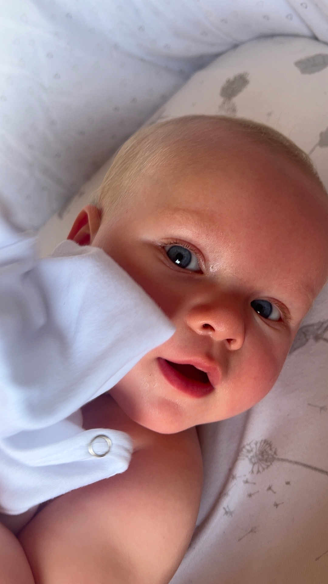 Archie joined the competition — help win amazing prizes! baby, infant, face, blue_eyes, skin, white_clothing, blanket, close_up, cute, child, portrait, lying_down, soft_light, expression, mouth_open, hand, fingertip, head, cheek, young