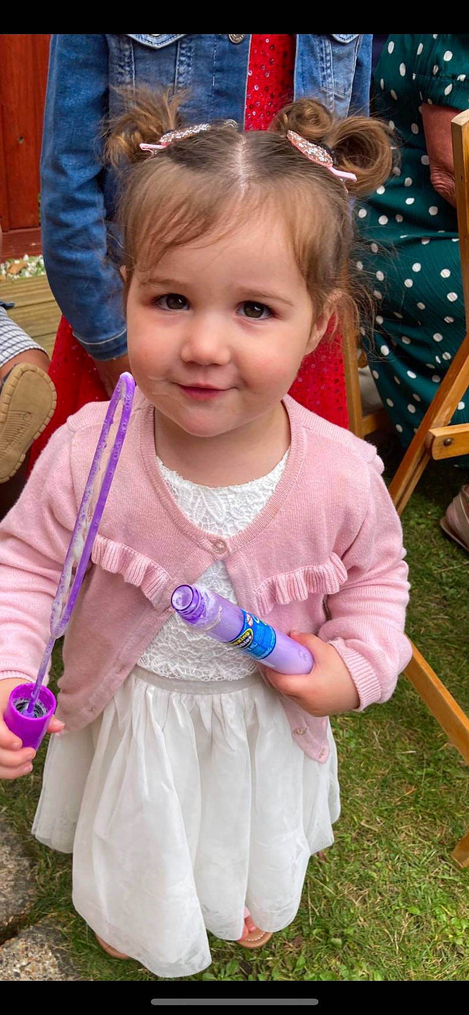 Erin is registered to the contest to win money with this photo: baby_toddler_clothing, blue, cheek, child, face, facial_expression, fun, grass, hairstyle, happy, head, iris, joy, organ, person, photograph, pink, purple, skin, toddler