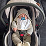 Inacio a rejoint le concours — aidez-le/la à gagner de superbes lots ! baby, bib, blanket, car_seat, child, clothing, comfort, couch, cute, face, furniture, indoor, infant, knit_hoodie, pacifier, person, portrait, rest, seatbelt, socks