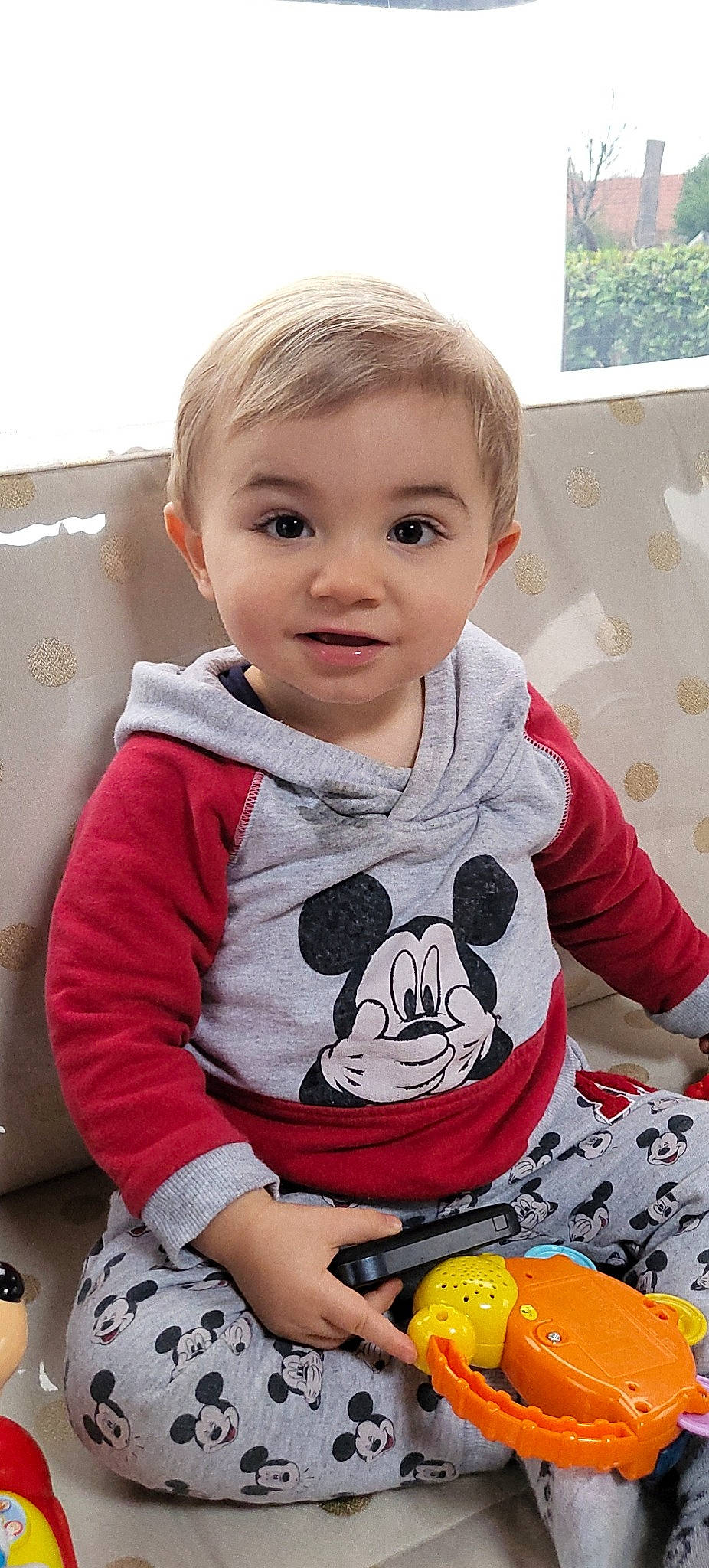 Andy participe au concours pour gagner de l'argent avec cette photo : arm, baby, baby_toddler_clothing, bowl, cheek, child, comfort_food, flooring, happy, hoodie, long_sleeved_t_shirt, pajamas, pattern, person, play, sitting, sleeve, t_shirt, tableware, toddler