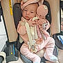 baby, infant, car_seat, pink_clothing, unicorn_hood, crocheted_toy, octopus_toy, pacifier, cute, soft_texture, indoor, child, newborn, sleepy, cozy, pastel_colors, hand, footwear, seat_belt, child_safety