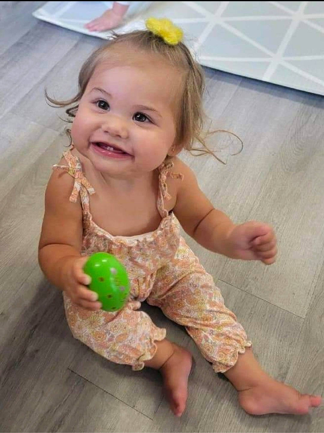 Eviana is registered to the contest to win money with this photo: arm, baby, baby_toddler_clothing, barefoot, cheek, child, finger, flooring, foot, fun, gesture, hand, happy, head, iris, joy, person, skin, sleeve, smile