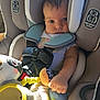 baby, car_seat, child, plush_toy, straps, seatbelt, infant, cute, sunlight, hand, face, safety, child_safety, car_interior, clothing, seat_padding, portrait, young_child, indoor, close_up