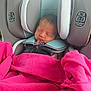 newborn, baby, car_seat, blanket, sleeping, infant, child, pink, fabric, safety, seat_belt, cushion, head_support, clothing, indoor, side_impact_tested, resting, young_child, peaceful, portrait