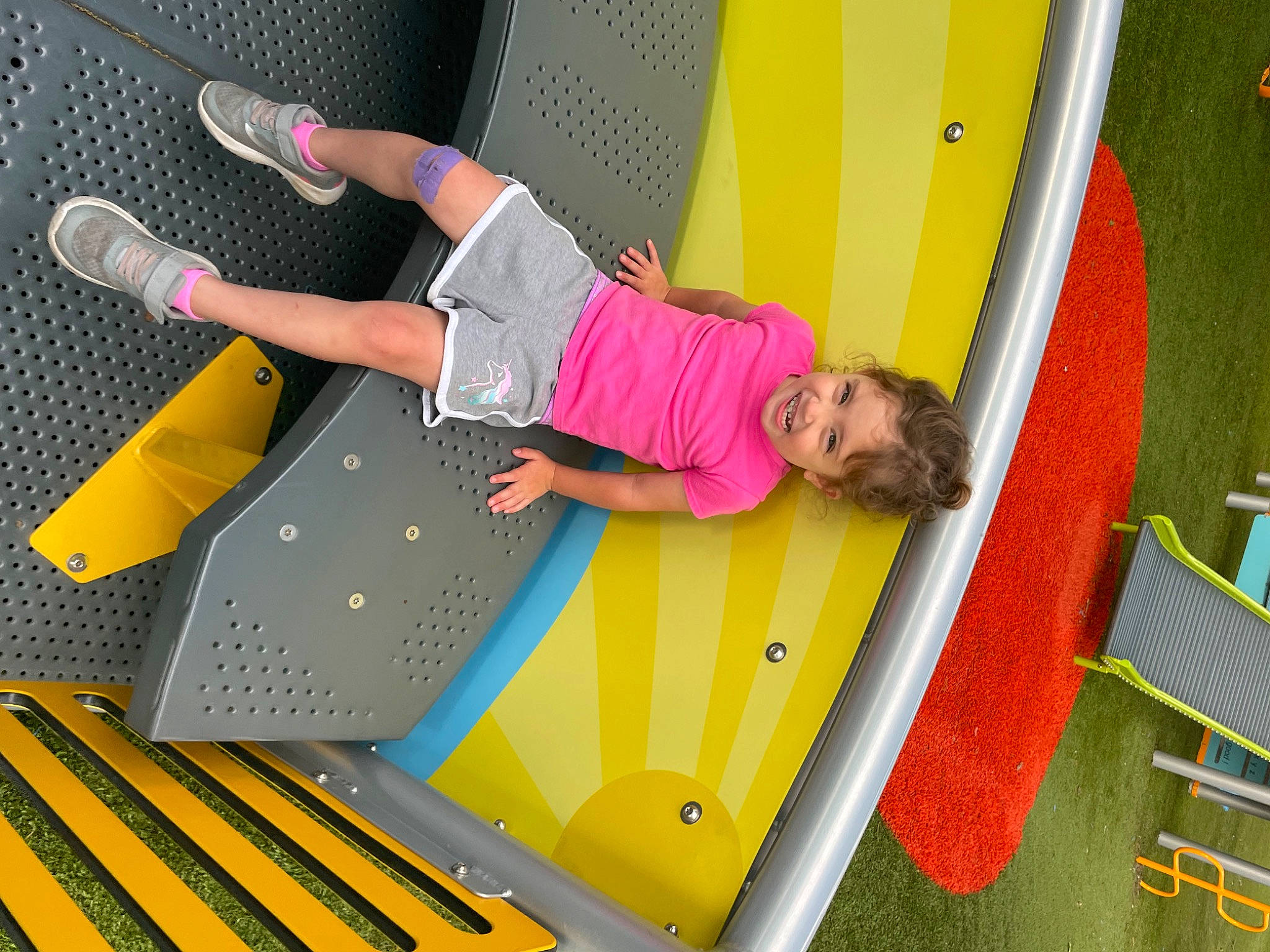 Lilyanne joined the competition — help win amazing prizes! balance, ceiling, child, flooring, fun, green, human_leg, joy, knee, leisure, pattern, person, play, playground, recreation, room, shorts, t_shirt, thigh, toddler