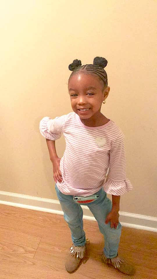 Zion is registered to the contest to win money with this photo: child, hair, hairstyle, happy, joint, joy, neck, person, shoe, shoulder, sleeve, standing, t_shirt, toddler