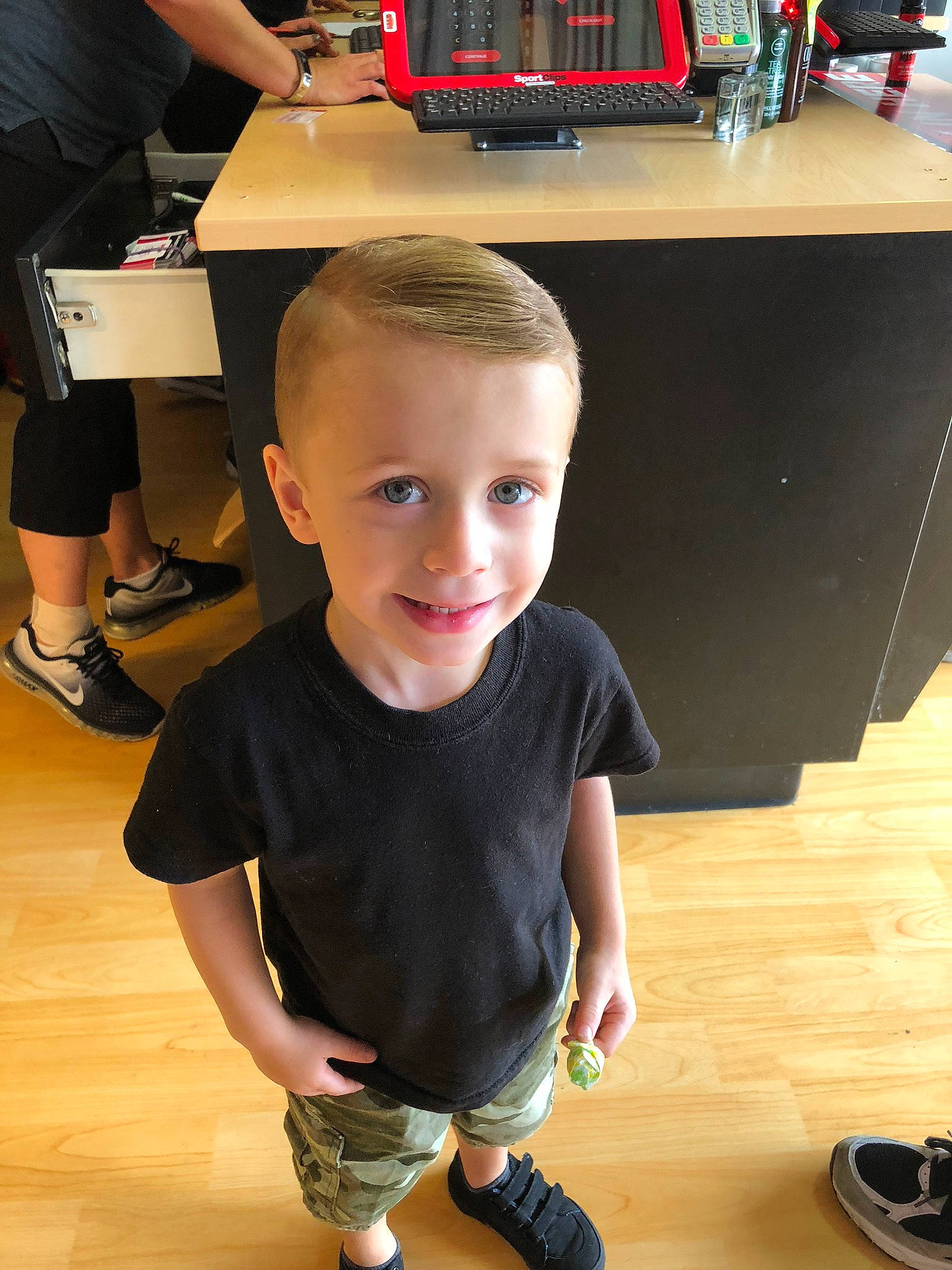 Robert is registered to the contest to win money with this photo: arm, child, finger, floor, flooring, fun, leg, male, person, play, shoe, standing, t_shirt, toddler, wood