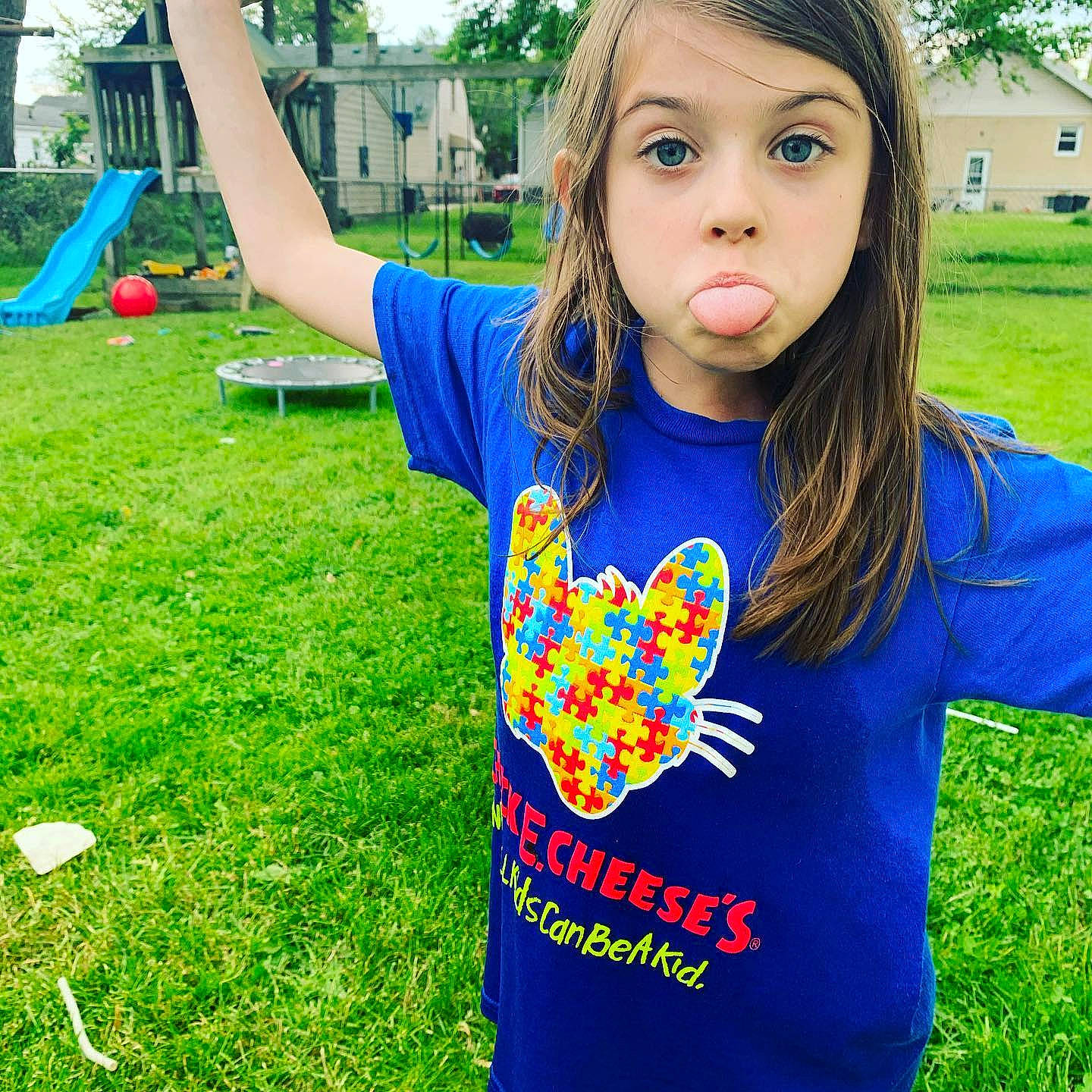 Rachel is registered to the contest to win money with this photo: blue, child, cool, electric_blue, facial_expression, fun, grass, grassland, green, happy, leaf, leisure, nature, people, people_in_nature, person, plant, sleeve, summer, t_shirt