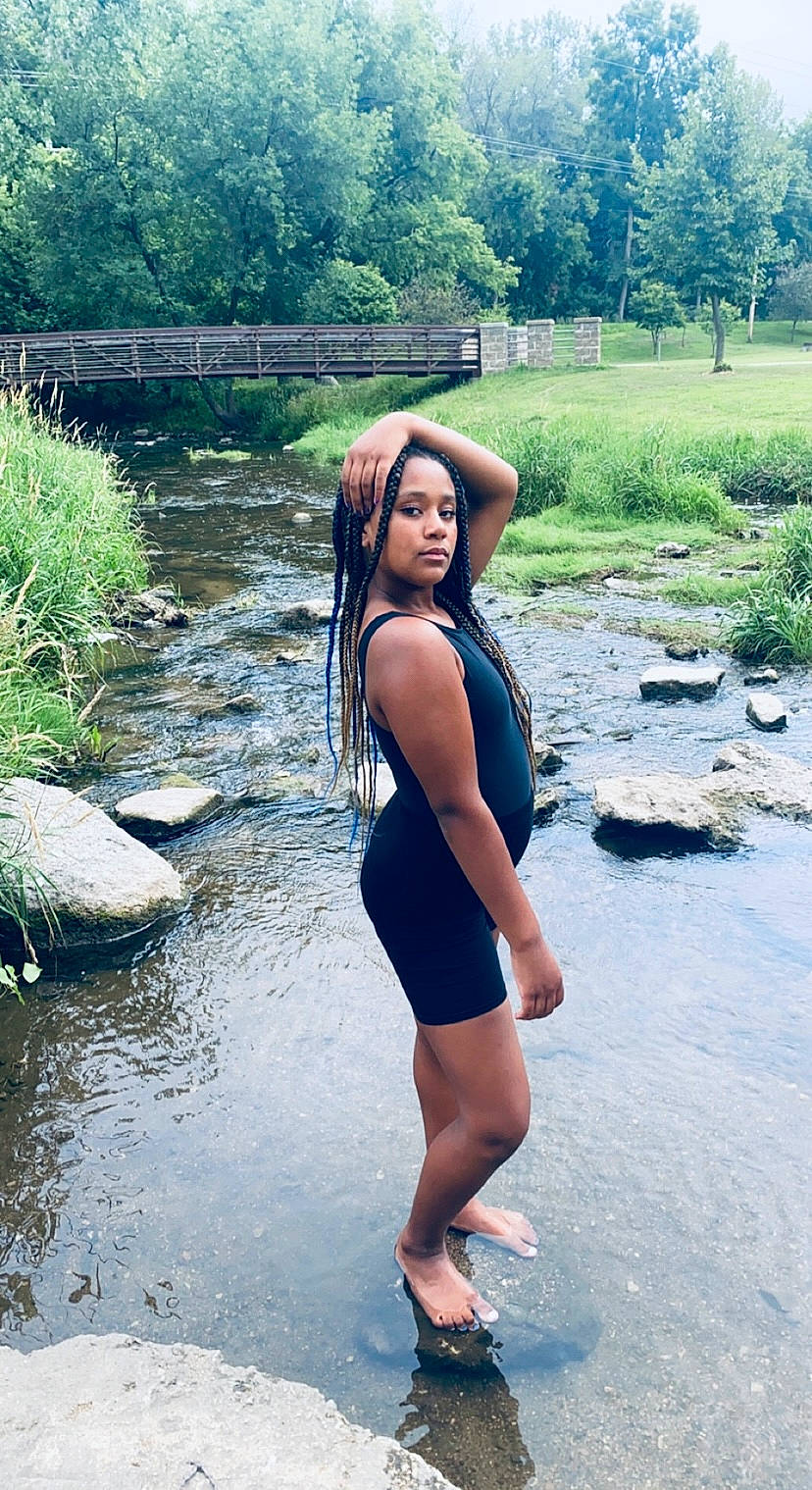 Kinley is registered to the contest to win money with this photo: black_hair, flash_photography, grass, happy, knee, lake, landscape, leg, leisure, long_hair, natural_environment, people_in_nature, person, plant, summer, sunlight, thigh, tree, waist, water