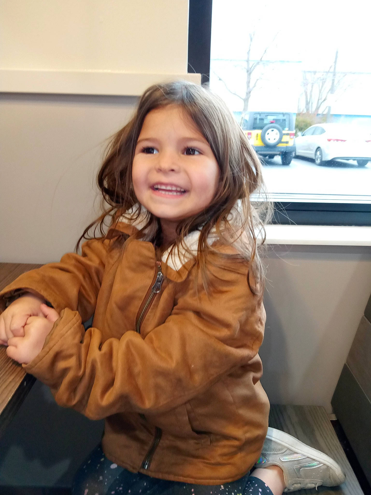 Nova is registered to the contest to win money with this photo: blond, brown_hair, car, cheek, child, flooring, fun, fur, happy, iris, jacket, joy, leather_jacket, luxury_vehicle, person, sitting, skin, sleeve, smile, standing