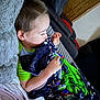 Itachi joined the competition — help win amazing prizes! child, blanket, couch, indoor, resting, cozy, comfort, toddler, face, clothing, home, furniture, relaxation, soft, person, sleepy, tattoo, arm, green_shirt, patterned_blanket