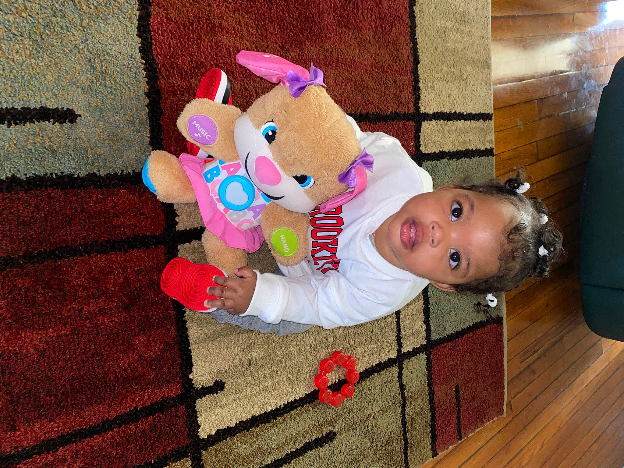 Avianna is registered to the contest to win money with this photo: baby, baby_products, baby_toddler_clothing, baby_toys, carmine, child, flooring, fun, happy, magenta, person, pink, plush, smile, stuffed_toy, toddler, toy, wood