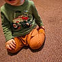 Wyatt is registered to the contest to win money with this photo: child, toddler, carpet, green_sweatshirt, orange_pants, toy_tractor, indoor, playtime, smiling, happy, floor, cat_tree, furniture, person, clothing, kid, cute, baby, home, carpet_pattern