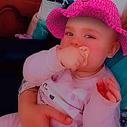 Kimberley a rejoint le concours — aidez-le/la à gagner de superbes lots ! baby, child, pacifier, pink_hat, hand, adult_hand, holding, indoor, furniture, dresser, clothing, person, face, sitting, cute, freckles, soft_lighting, home, relaxed, comfort