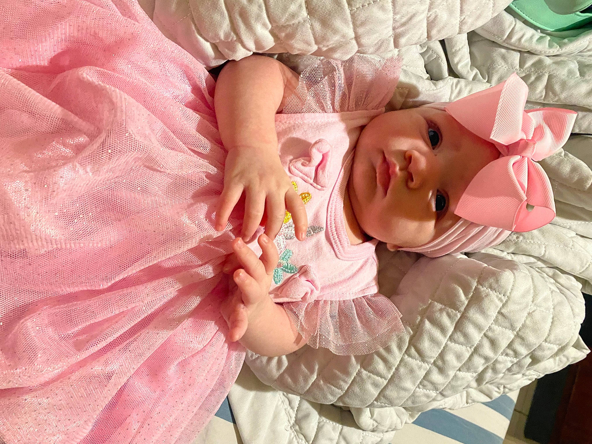 Scarlett is registered to the contest to win money with this photo: arm, baby_products, baby_toddler_clothing, child, comfort, eye, eyelash, fashion_accessory, hand, head, headwear, human_body, linens, magenta, nail, pattern, peach, person, pink, skin