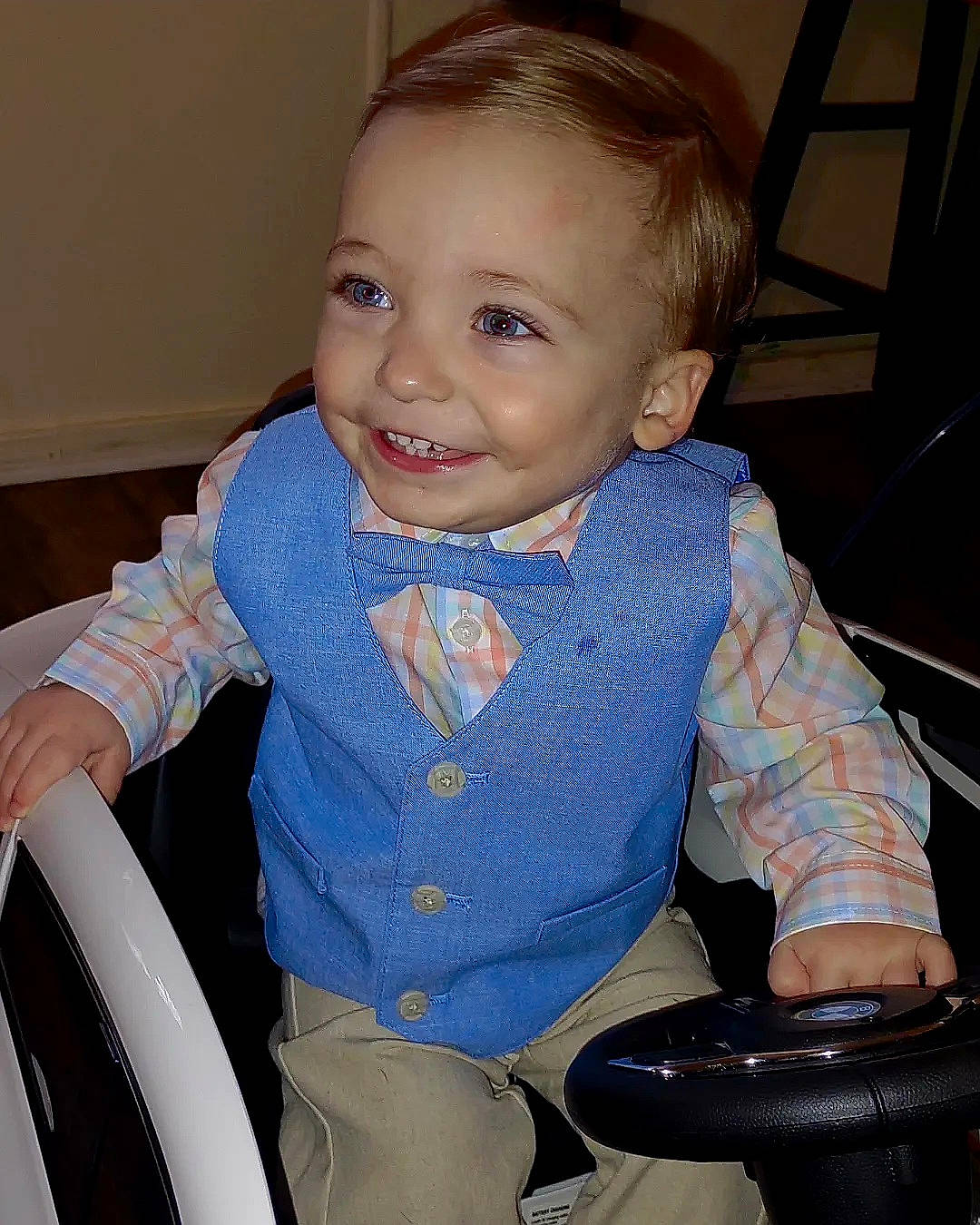 Kieran is registered to the contest to win money with this photo: arm, baby_toddler_clothing, chair, cheek, eye, face, finger, hair, hairstyle, hand, happy, head, human_body, joy, leg, neck, organ, person, product, skin