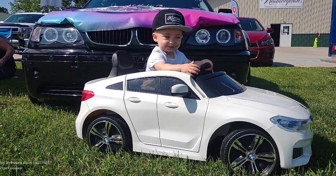 Kieran joined the competition — help win amazing prizes! alloy_wheel, automotive_design, automotive_exterior, automotive_lighting, automotive_tire, blue, bumper, car, fender, grille, headwear, hood, joy, land_vehicle, light, motor_vehicle, person, personal_luxury_car, plant, tire