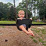 toddler, child, swing, playground, outdoor, park, trees, grass, dirt, bucket_swing, curly_hair, blonde, barefoot, summer_clothing, nature, daylight, person, young_child, holding, legs