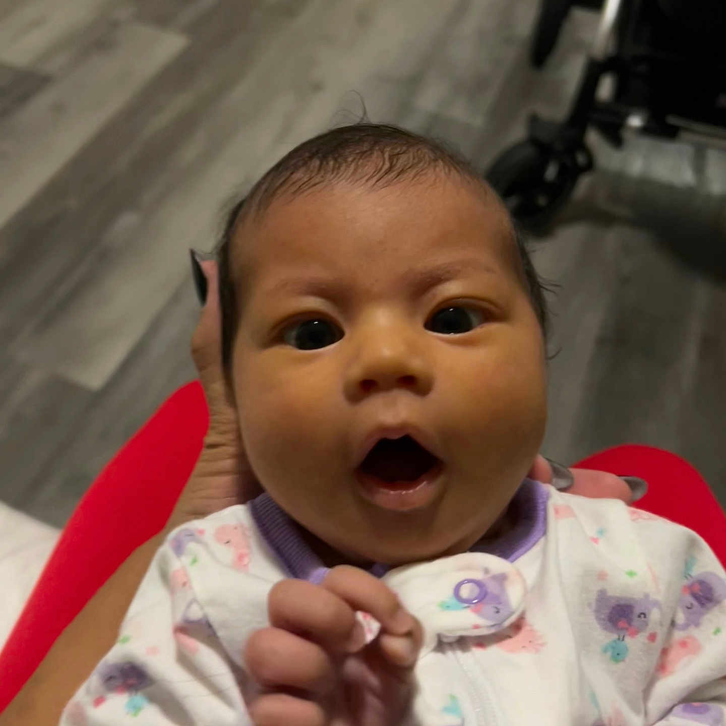 Aymee joined the competition — help win amazing prizes! animal_prints, baby, child, close_up, clothing, curious_expression, cute, floor, hand, holding, indoor, infant, nails, onesie, open_mouth, person, portrait, purple_trim, stroller, wide_eyes