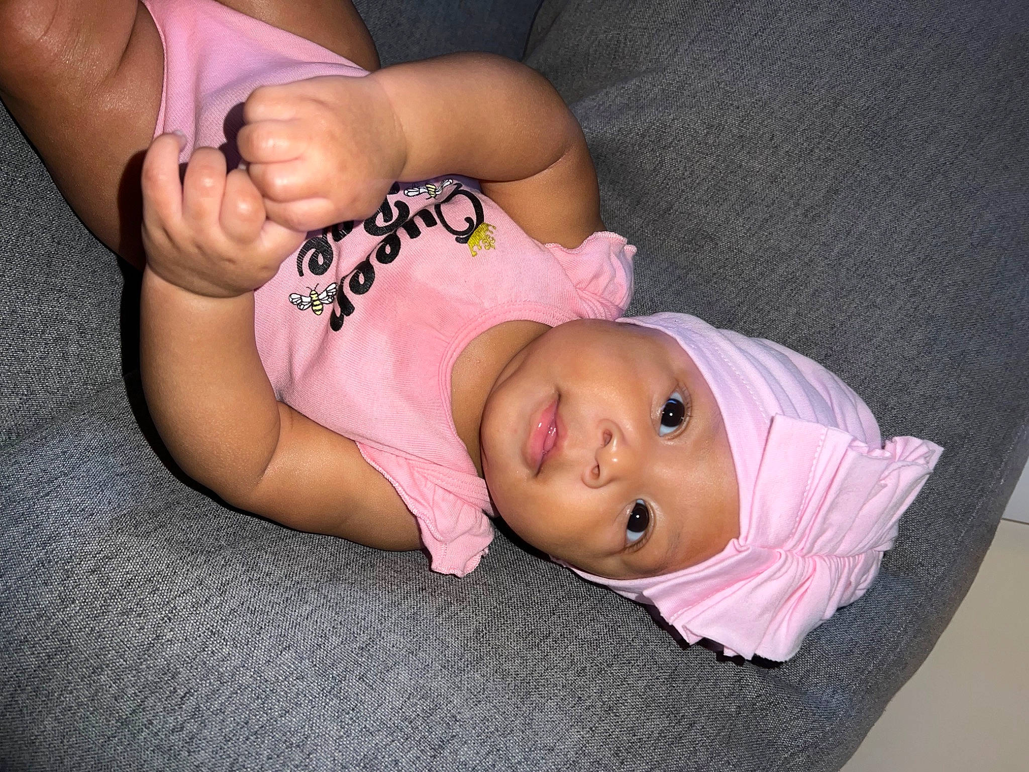 Kali is registered to the contest to win money with this photo: baby, baby_toddler_clothing, cheek, child, comfort, eyelash, finger, glasses, hand, hat, headgear, headwear, human_body, lip, mammal, mouth, person, pink, skin, textile