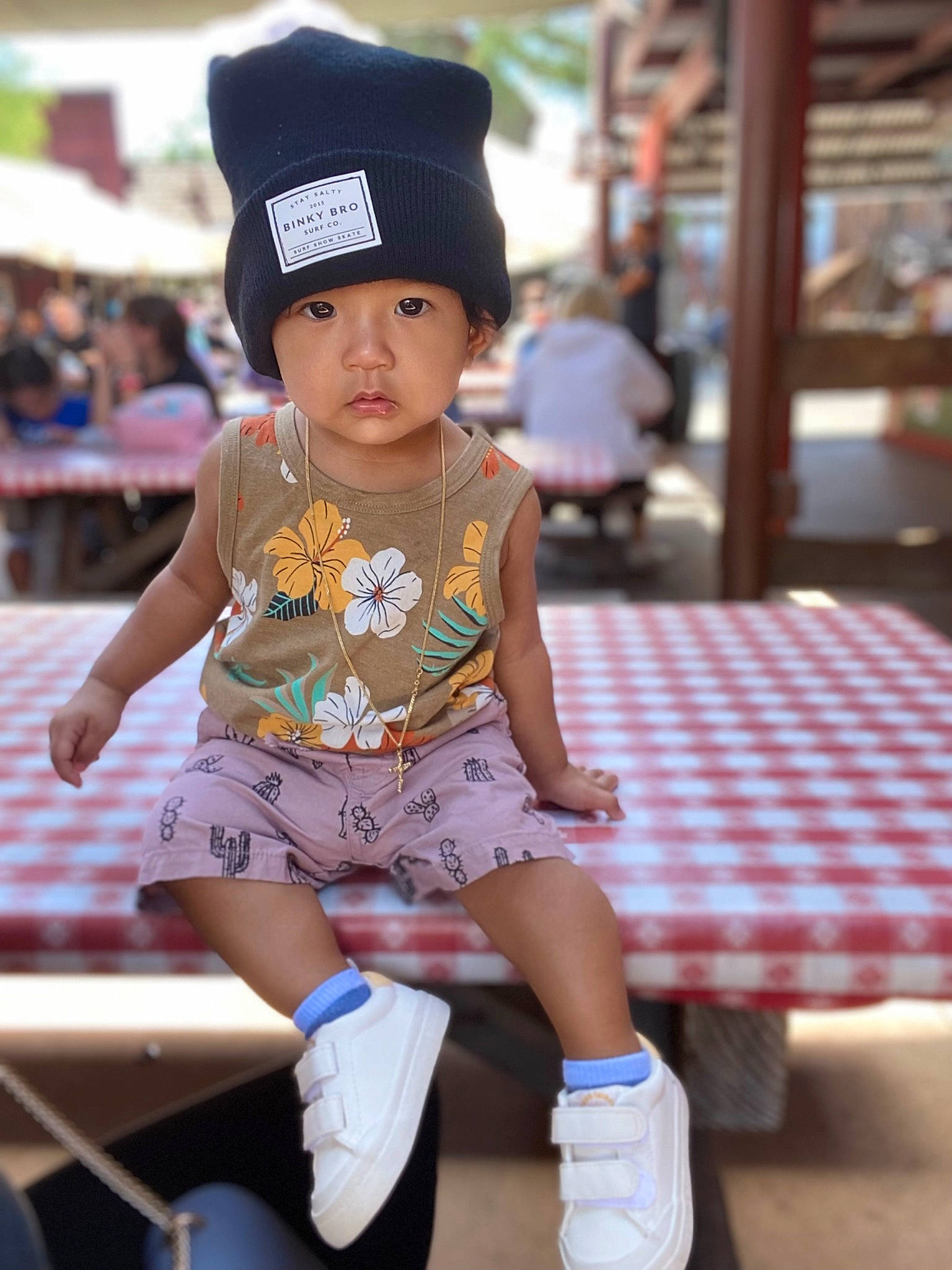 Shawn is registered to the contest to win money with this photo: cap, child, costume, event, fun, hairstyle, headwear, human_leg, leisure, pattern, person, plaid, recreation, shorts, sitting, sock, street_fashion, table, tartan, thigh