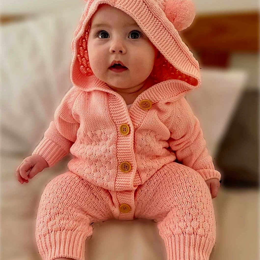 Jasmine is registered to the contest to win money with this photo: baby, bonnet, cap, clothing, crawling, doll, face, happy, hat, head, hood, knitwear, pants, person, photography, portrait, sitting, smile, sweater, toy