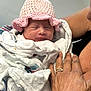 Rhylee joined the competition — help win amazing prizes! newborn, baby, infant, pink_hat, crocheted_hat, blanket, hand, ring, adult, skin, closeup, sleeping, wrapped, soft, cozy, tenderness, care, comfort, person, portrait