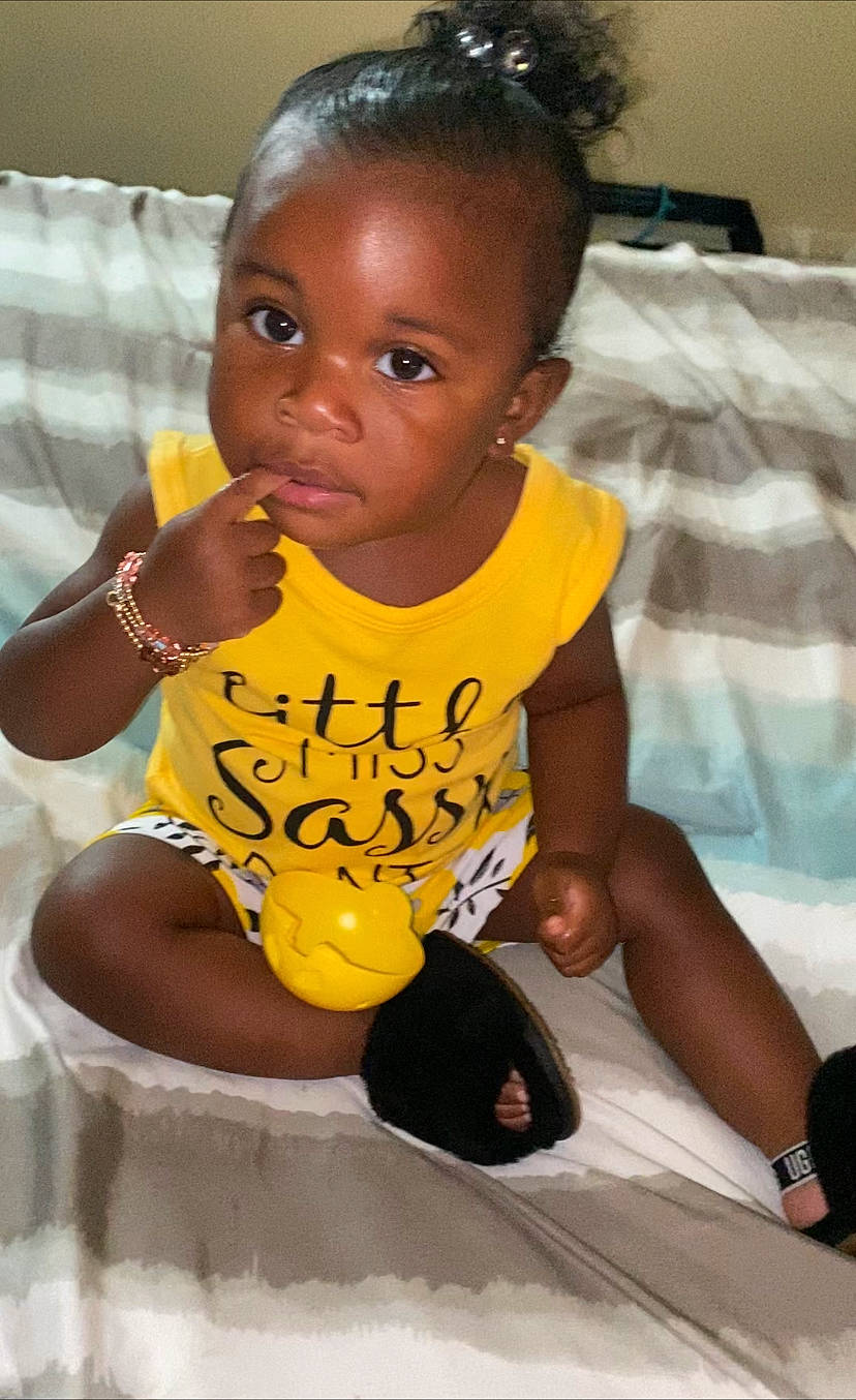 Anavi is registered to the contest to win money with this photo: baby, baby_toddler_clothing, beauty, black, cheek, child, chin, eye, fun, hairstyle, happy, human, nose, organ, person, skin, sleeve, t_shirt, thigh, toddler