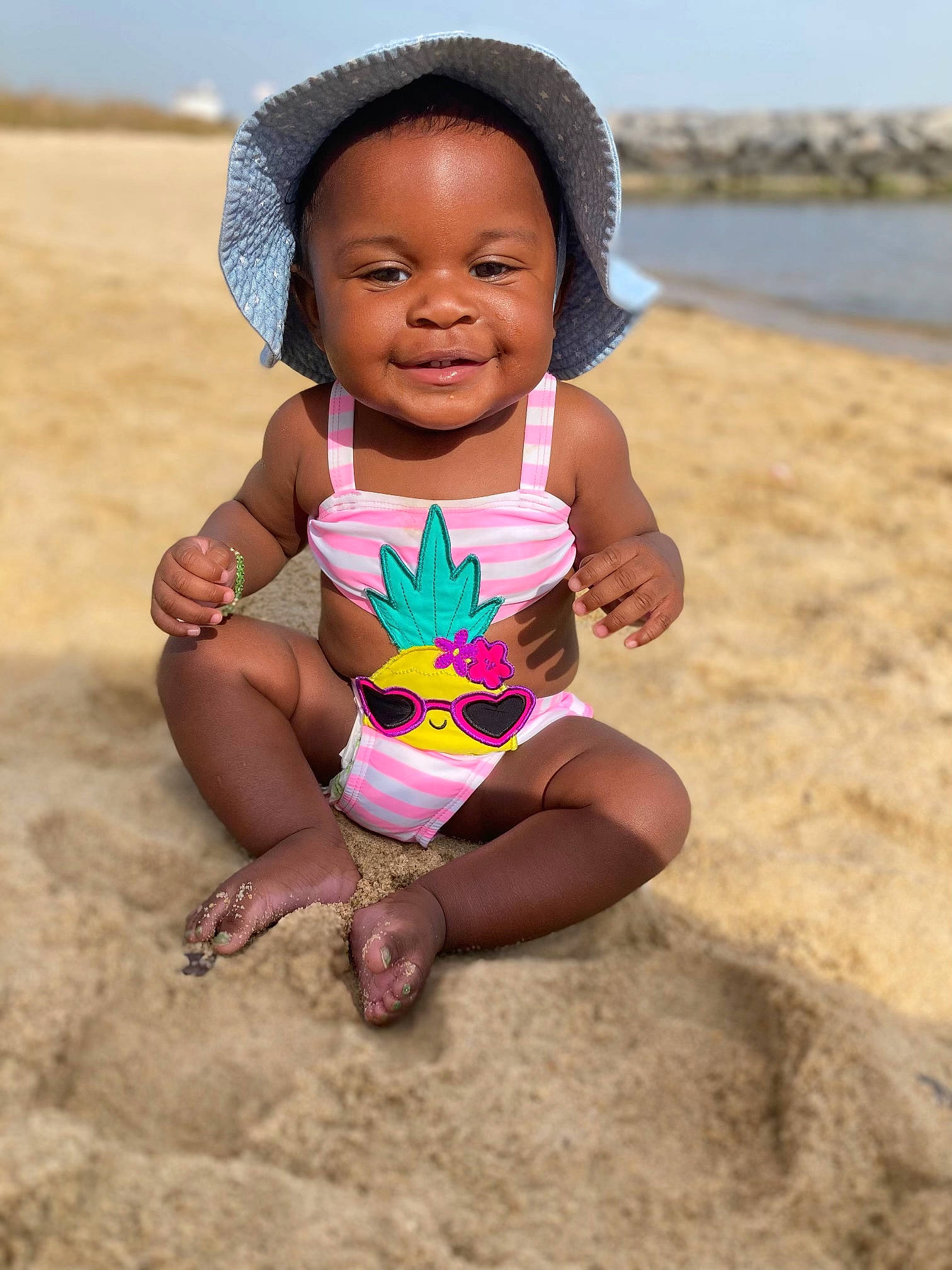 Anavi joined the competition — help win amazing prizes! baby_toddler_clothing, beach, child, finger, fun, happy, head, headgear, joy, leisure, people, people_in_nature, people_on_beach, person, sky, smile, summer, sun_hat, thigh, toddler