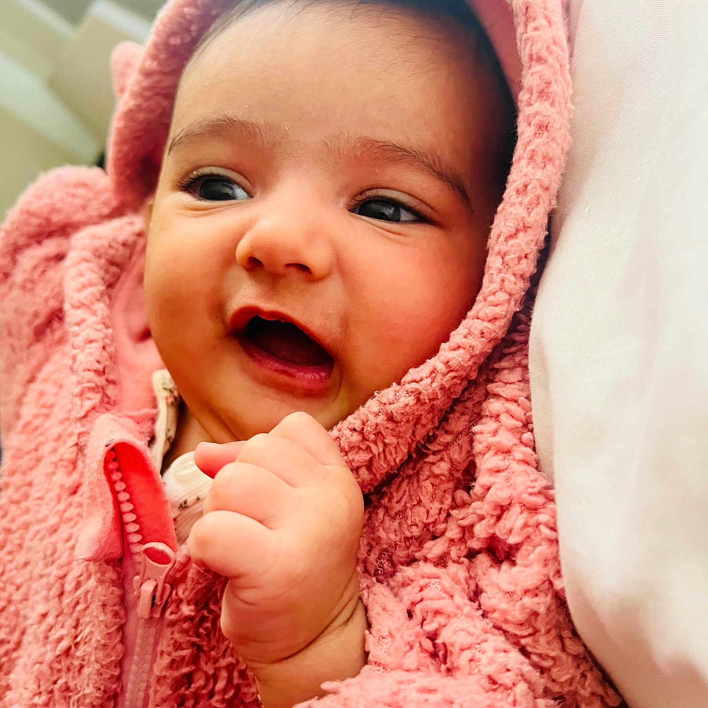 Aishvi is registered to the contest to win money with this photo: baby, bedding, blanket, child, close_up, cozy, eyes, face, fingers, fleece, hand, happy, hoodie, indoor, infant, pink, portrait, skin, smile, zipper