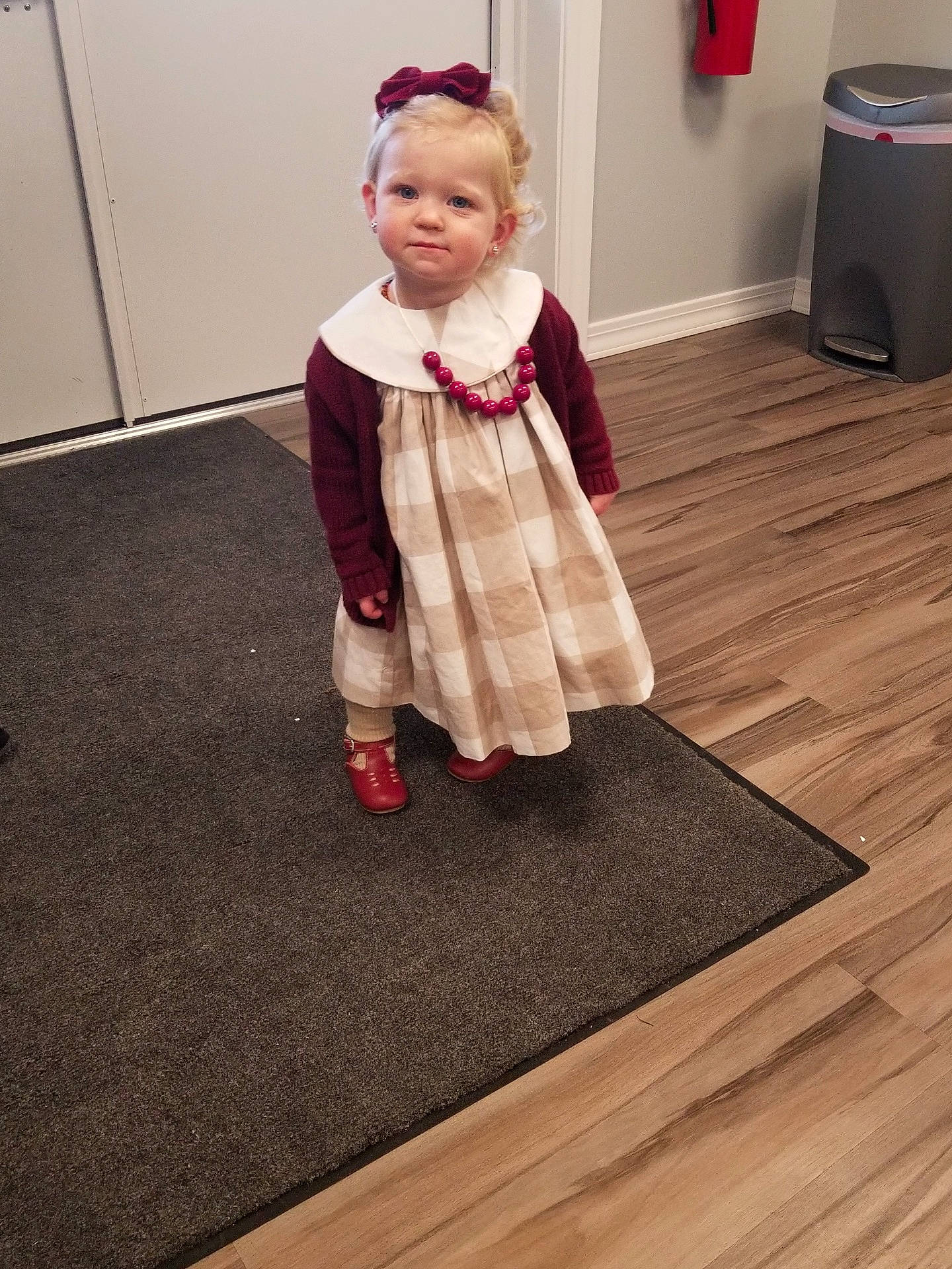 Kyndal joined the competition — help win amazing prizes! baby, baby_toddler_clothing, carpet, child, costume, door, dress, floor, flooring, hair_accessory, hardwood, home_appliance, laminate_flooring, one_piece_garment, person, sock, standing, toddler, waste_containment, wood_flooring