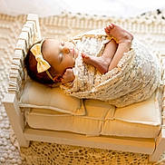 Kiana joined the competition — help win amazing prizes! newborn, baby, sleeping, lace, bow, headband, wooden_bed, cushion, blanket, cozy, soft, cute, infant, wrapped, portrait, resting, indoors, peaceful, toddler, child