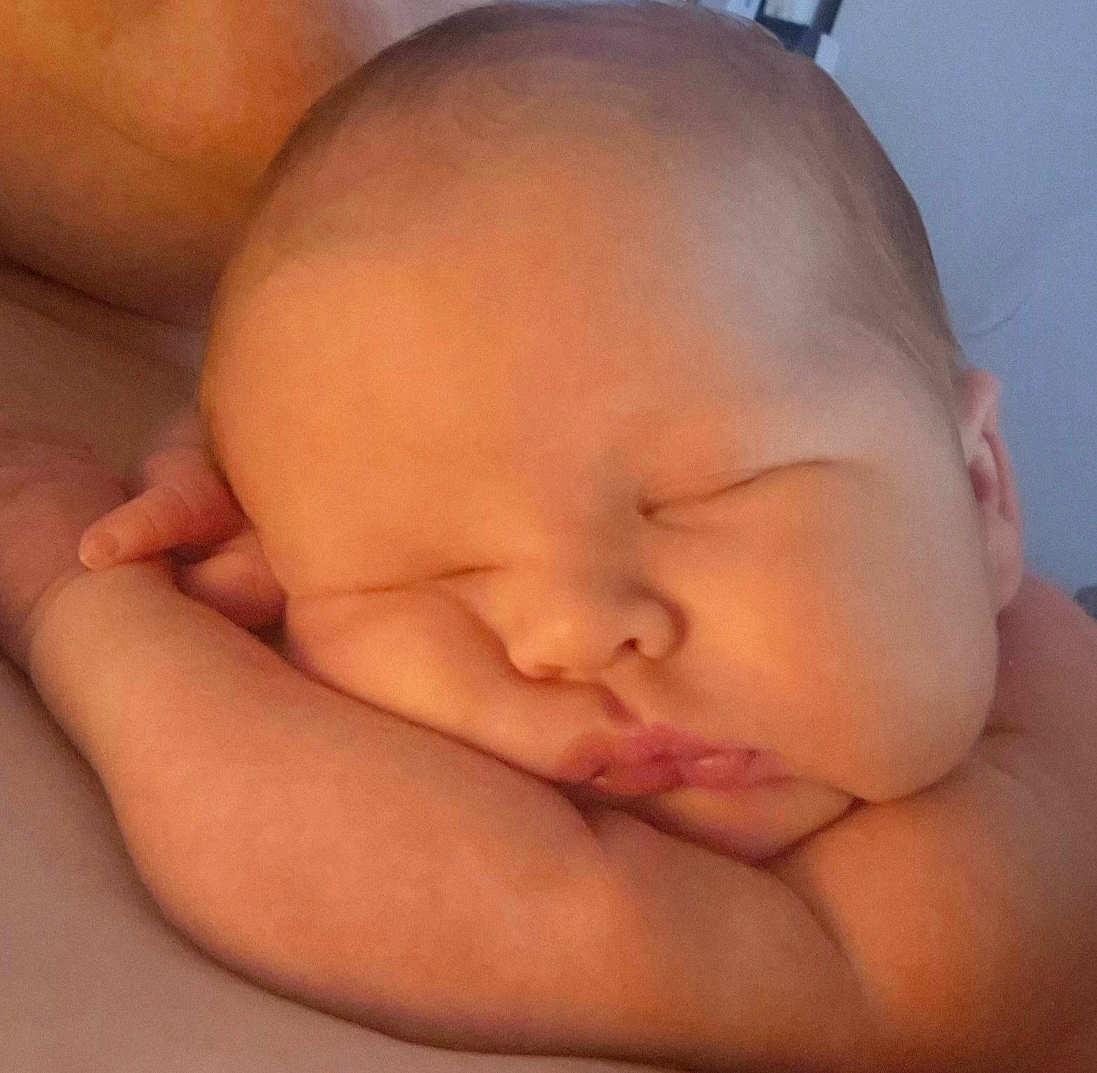 Hugo is registered to the contest to win money with this photo: baby, sleeping, close_up, arm, face, peaceful, skin, infant, newborn, resting, cute, child, portrait, soft_light, indoors, peace, calm, head, expression, human