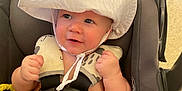 Aiden joined the competition — help win amazing prizes! baby, car_seat, white_hat, bottle, infant, happy, smiling, hands, seatbelt, indoor, floor, child, cute, skin, headwear, young, person, feeding, safety, expression