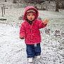 boots, child, cold_weather, curious, cute, daytime, fence, grass, hat, jeans, nature, outdoor, person, pink_coat, snow, snowfall, toddler, trees, winter_clothing, yard