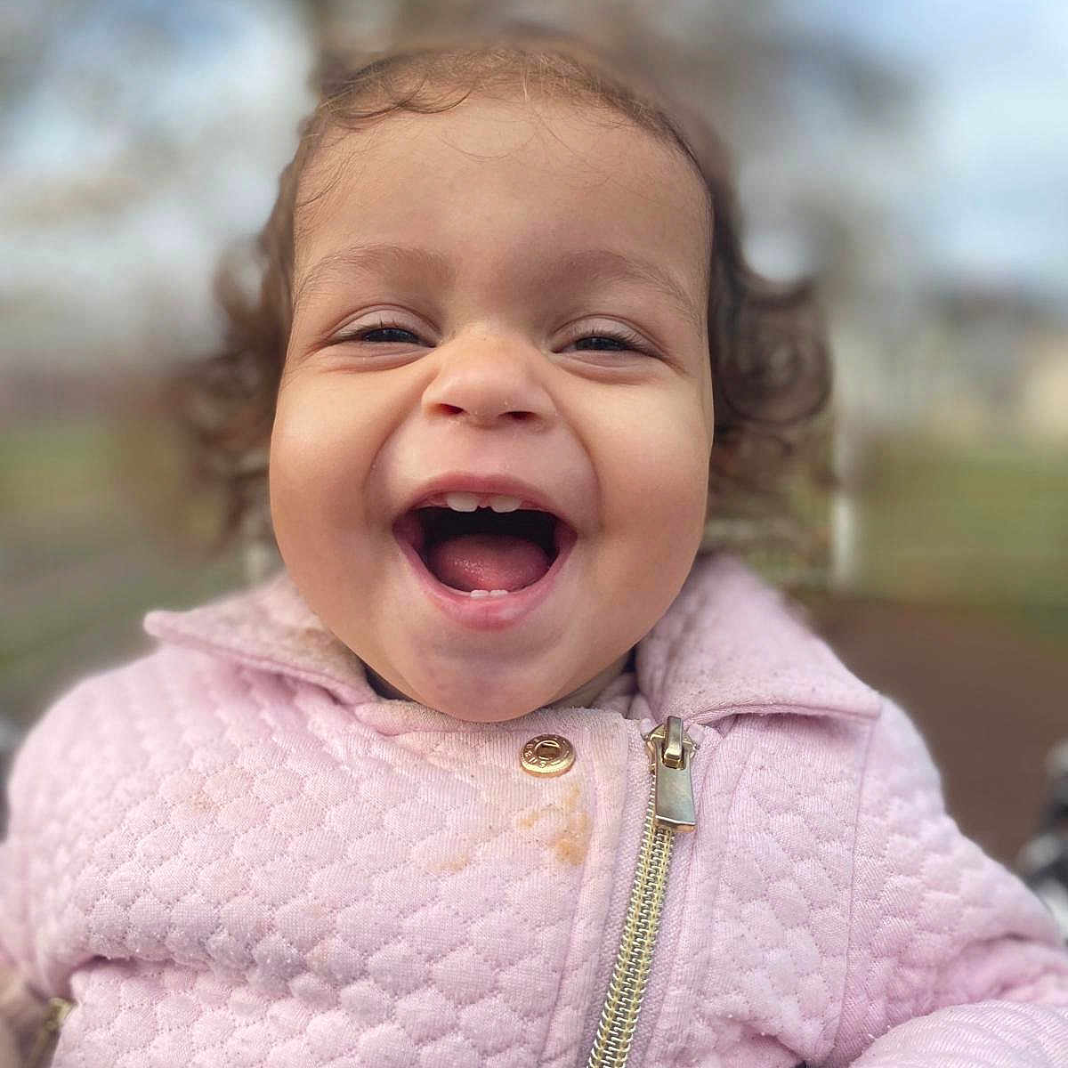 Nélya participe au concours pour gagner de l'argent avec cette photo : child, closeup, curly_hair, cute, expression, face, fun, happy, jacket, joy, laughing, outdoor, person, pink_clothing, portrait, smiling, toddler, warm_clothing, young_child, zipper