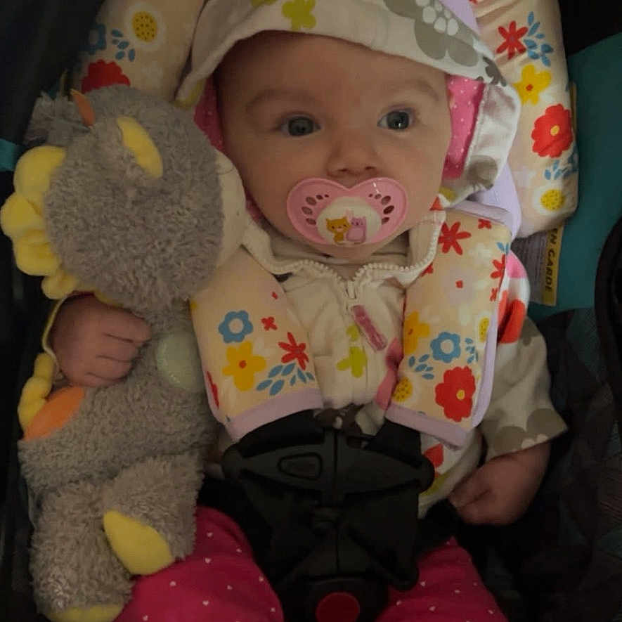 Astrid joined the competition — help win amazing prizes! baby, car_seat, child, clothing, comfort, cozy, cute, face, floral_pattern, hoodie, infant, pacifier, pink_pants, polka_dot, seat_belt, sitting, small_hand, stuffed_animal, toy, white_socks