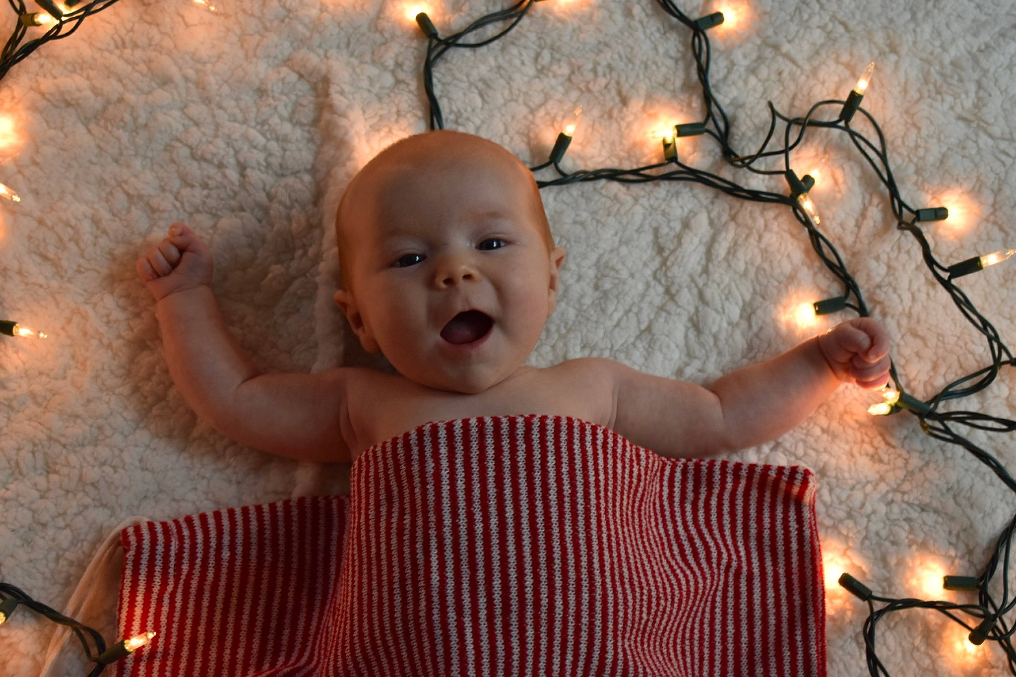 Evie joined the competition — help win amazing prizes! baby, baby_toddler_clothing, christmas_decoration, christmas_ornament, finger, flash_photography, fun, hair, hairstyle, hand, happy, head, lighting, orange, organ, ornament, person, sky, tree, twig